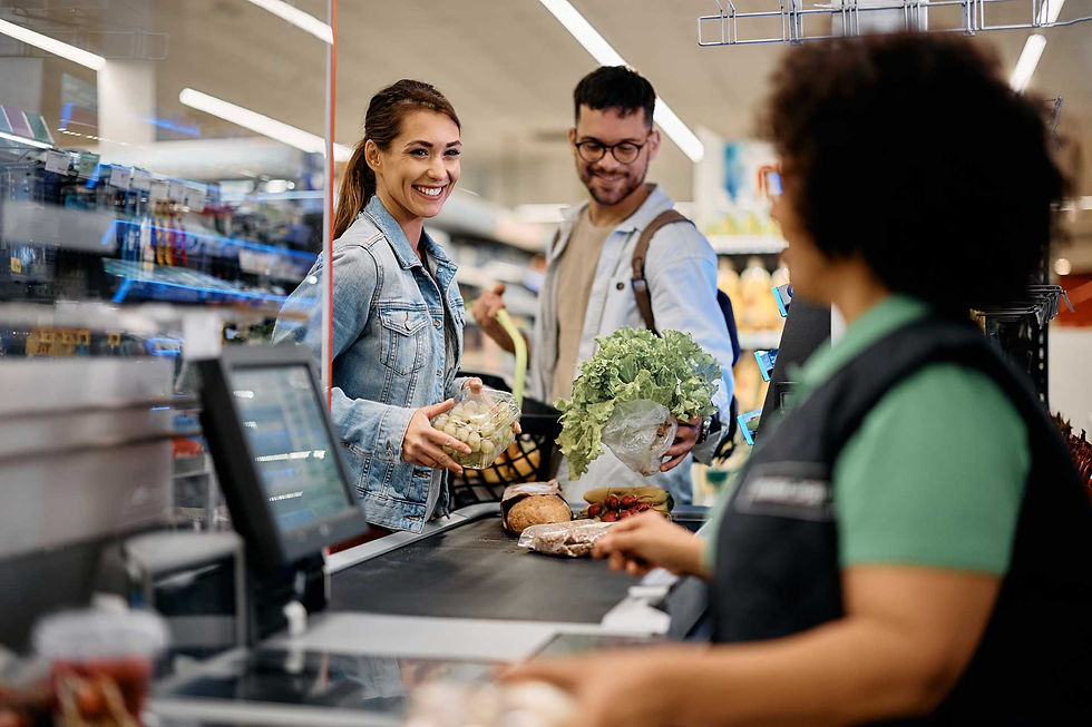 Complete Audiences - a server checking out products on a conveyor belt with shoppers smiling