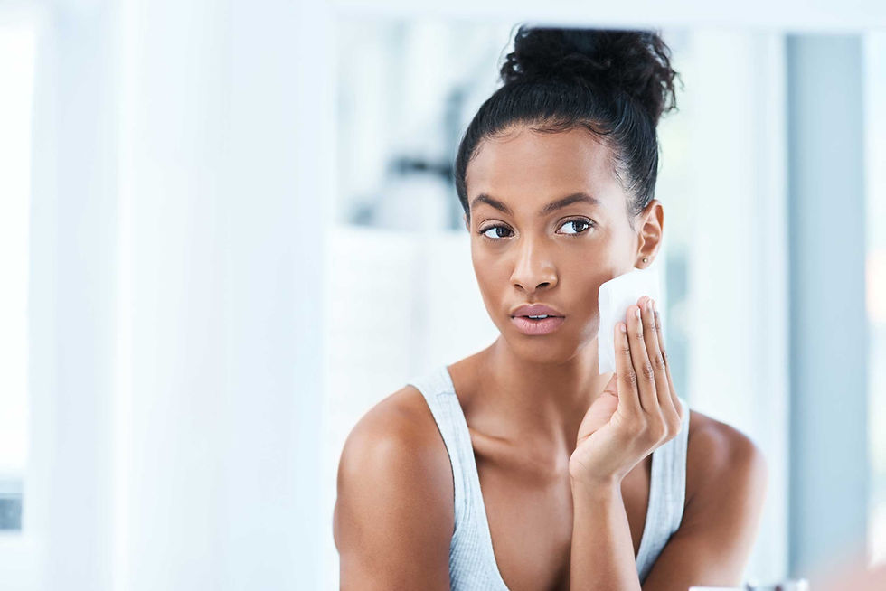 Complete Beauty - woman cleaning her face with beauty products
